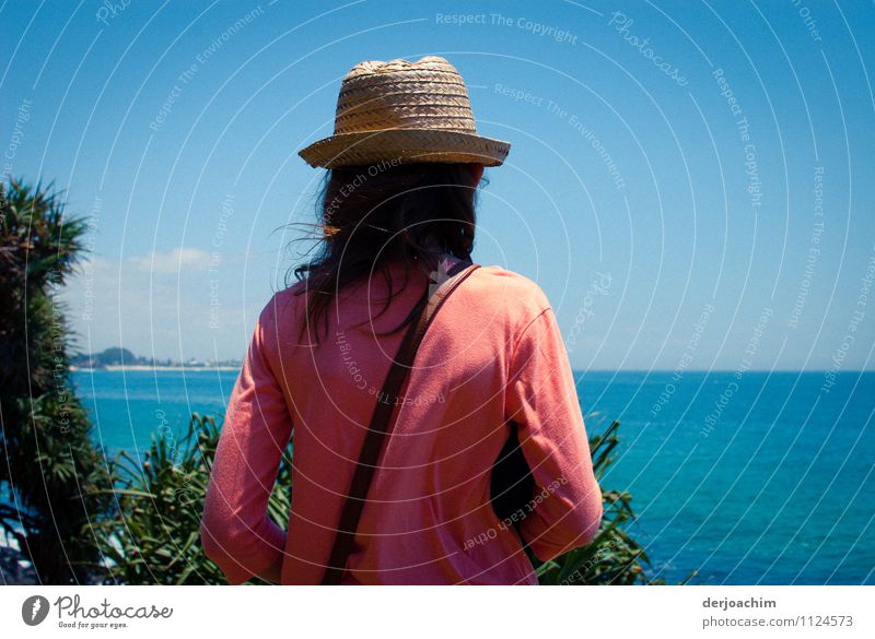 A girl with a hat and red jacket is waiting for the whales at the steep coast with a view of the sea. Joy Harmonious Leisure and hobbies Trip Girl Body 1