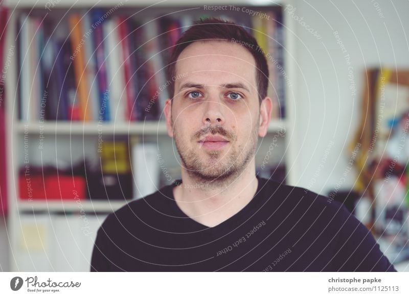 young man looks into the camera, bookshelf in the background Human being Young man Flat (apartment) Adults Looking Selfie portrait Man Living or residing