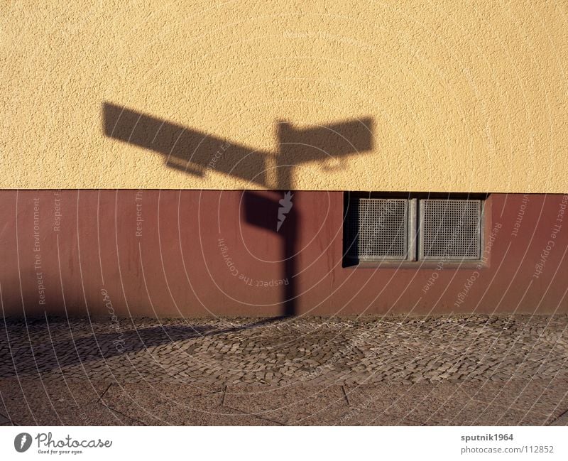 shadow shield Signs and labeling Wall (building) Brown Cellar window Architecture Street Shadow Corner