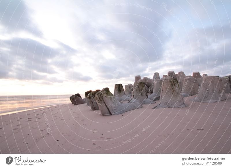 Bollard dance at the sea Nature Landscape Plant Sand Water Sky Clouds Sunrise Sunset Summer Beautiful weather Beach North Sea Deserted Manmade structures