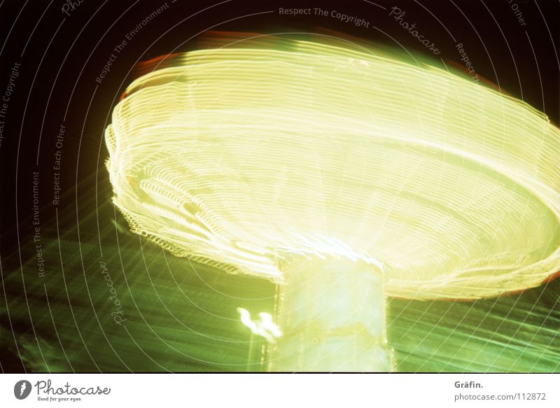 it rotates Fairs & Carnivals Chairoplane Rotate Speed Swirl Light Speed of light Carousel Electric bulb Lamp Strip of light Long exposure To hold on Night Dark