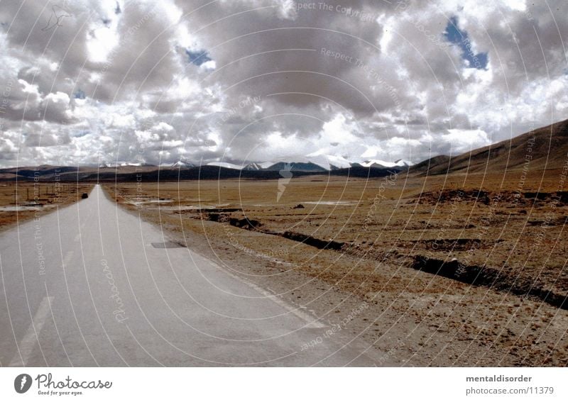 vast country Far-off places Badlands Grass Edge Roadside Going Horizon Clouds Brown Gray Street Nature Sky heaven Line End Lanes & trails Mountain Middle Closed