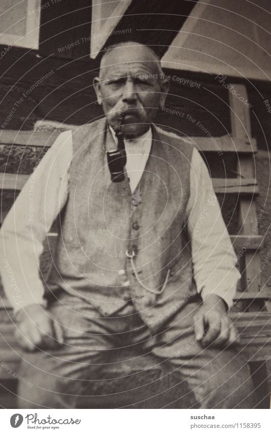 old man with snood and pipe sitting on a bench - old photo Black & white photo Analog Grandfather Great grandfather Old Memory Family & Relations Ancestors Past