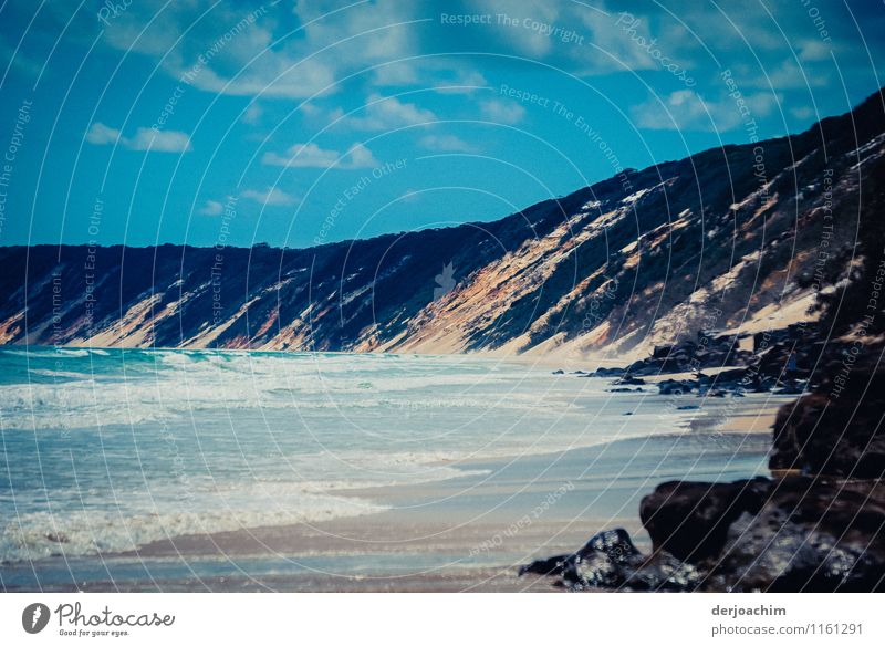 Steep coast washed up by waves with a blue sky. Joy Harmonious Leisure and hobbies Trip Environment Landscape Elements Water Summer Beautiful weather Beach