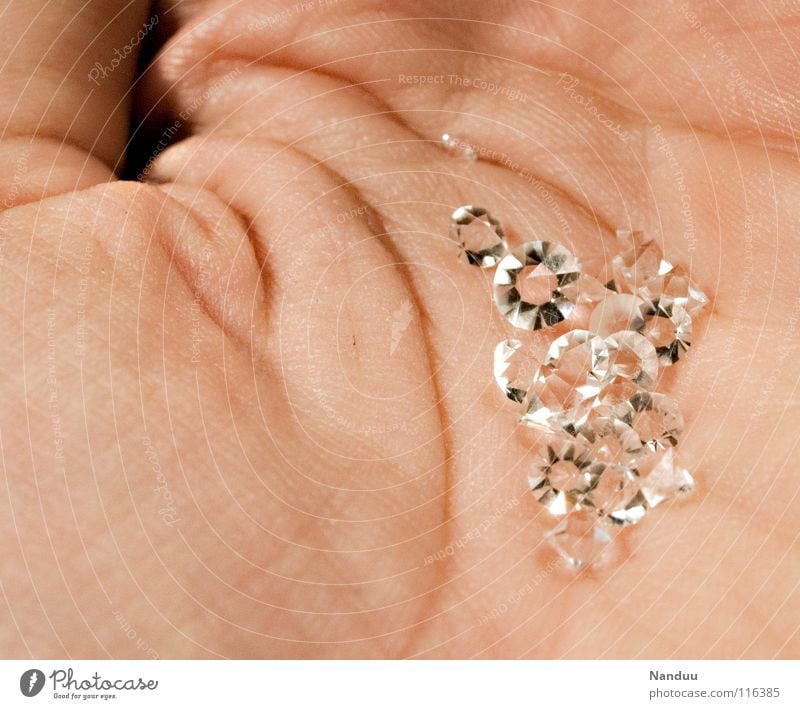 smuggled across To hold on Hand Safety (feeling of) Life line Precious stone Diamond Glittering Luxury Rich Capitalism Hard Stone Status symbol Swanky Expensive