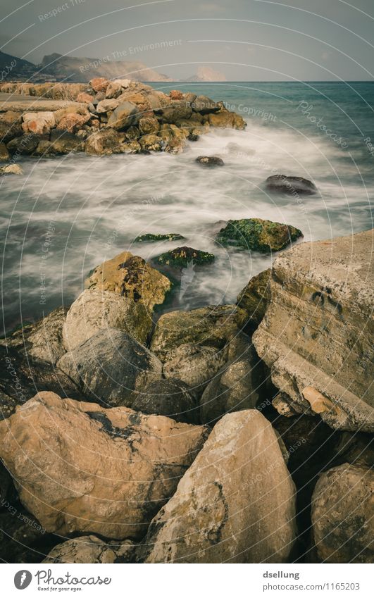 gentle surf. Environment Nature Landscape Elements Earth Water Sky Clouds Rock Waves Coast Ocean Thin Sharp-edged Cold Maritime Wet Strong Gloomy Brown Gray