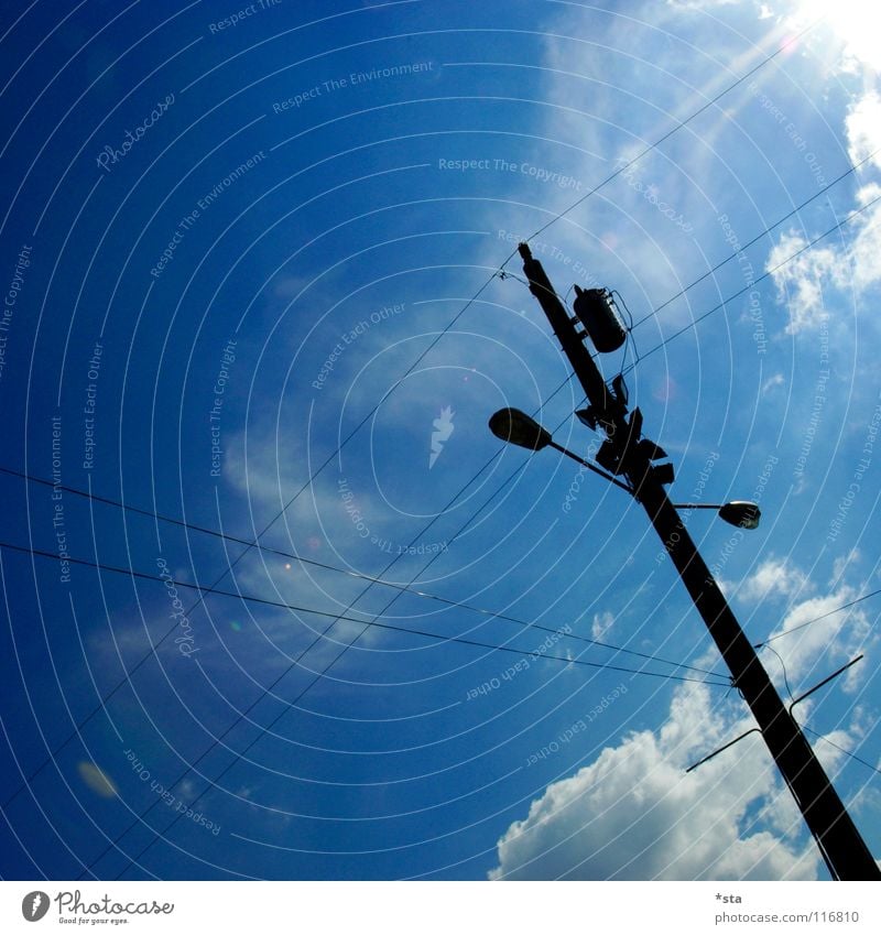 into the blue Lamp Lantern Electricity pylon Clouds Dazzle Silhouette Diagonal White Cross Industry Modern Traffic infrastructure Cable Sky Sun backlight scream