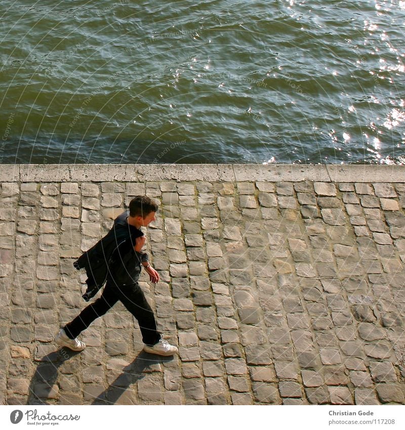 Walking France Paris Seine Louvre Man French Going To go for a walk Black Green White Footwear Bird's-eye view Water River cobblestone pavement Blue Shadow