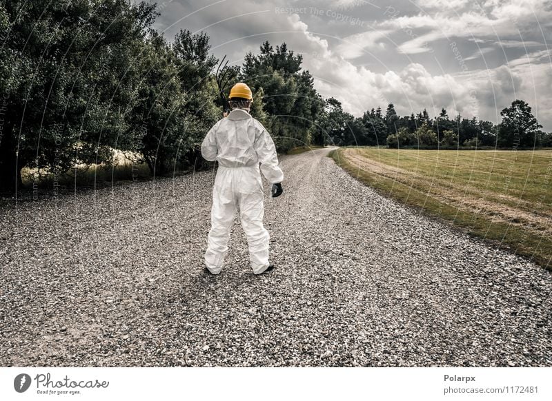 Worker looking down a road Fork Science & Research Work and employment Profession Industry Tool Human being Man Adults Nature Clouds Grass Street Suit Gloves