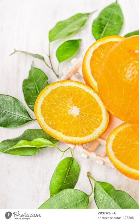 Cut orange with green leaves Food Fruit Orange Dessert Nutrition Organic produce Vegetarian diet Diet Juice Style Design Healthy Eating Life Summer Nature