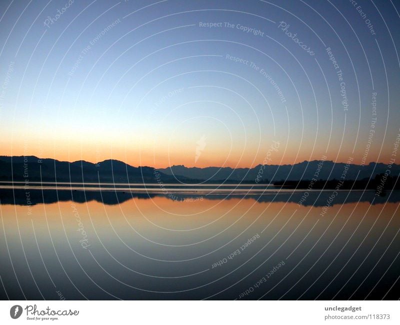 mirror image Lake Horizon Red Pfäffikon Lake Pfäffikersee Reflection Calm Vantage point Progress Water Evening Auslikon Blue Smoothness Clarity Far-off places