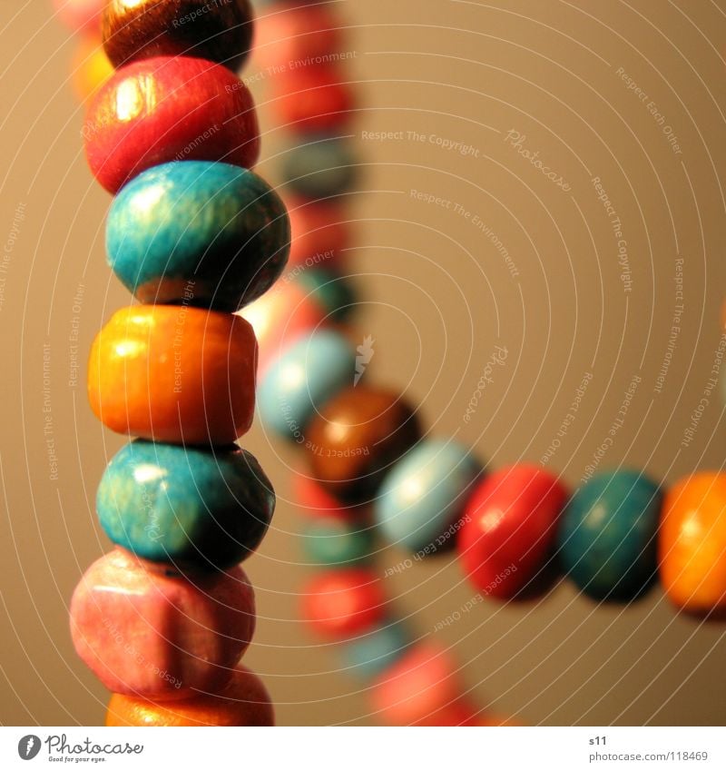 Jewellery. Luxury Beautiful Wood Blue Brown Pink Pearl necklace Wooden bead Neck Chain Orange distortion Close-up Macro (Extreme close-up)