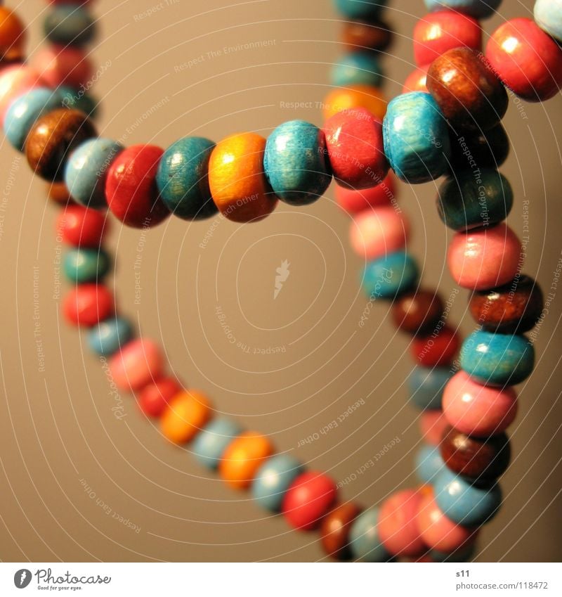 Jewellery. Luxury Decoration Wood Blue Brown Pink Pearl necklace Wooden bead Neck Chain Orange distortion Close-up Macro (Extreme close-up)