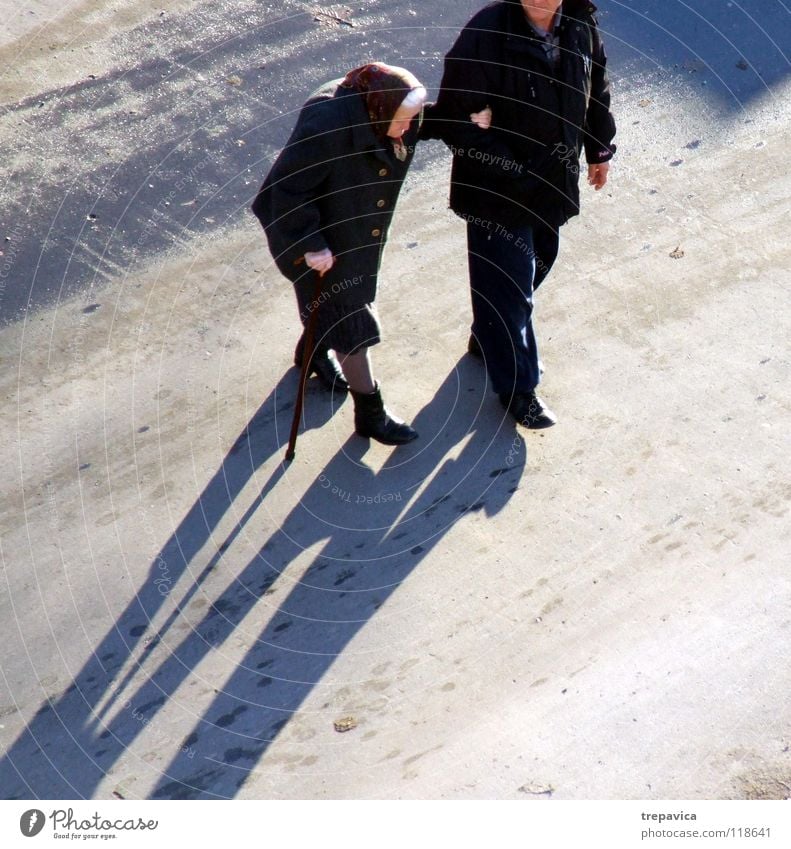 ... in common... Together 2 Human being Black Woman Senior citizen Friendship To go for a walk Bird's-eye view Couple Walking stick Demography Town Walking aid