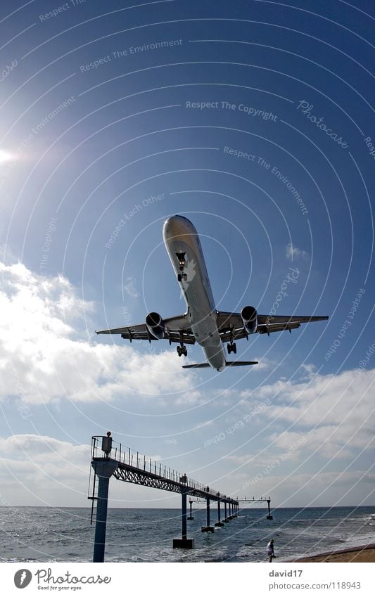 On approach Airplane Large Airplane landing Ocean Lanzarote Wide angle Back-light Airport Europe Aviation Airbus Runway Water arecife Island