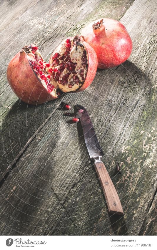 Pomegranate on wooden table Fruit Dessert Eating Vegetarian diet Diet Juice Table Old Dark Fresh Retro Juicy Red Colour knife vintage food ripe sweet Organic