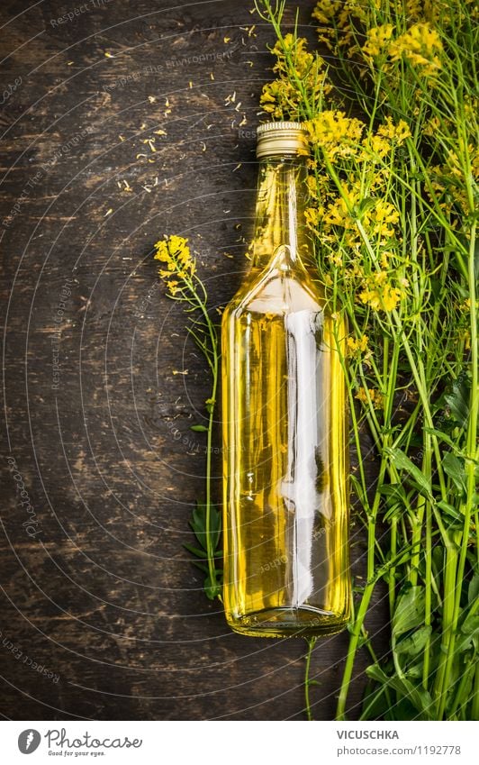 Fresh rapeseed oil on a wooden table Food Cooking oil Nutrition Bottle Glass Style Design Healthy Eating Life Nature Plant Flower Agricultural crop Yellow