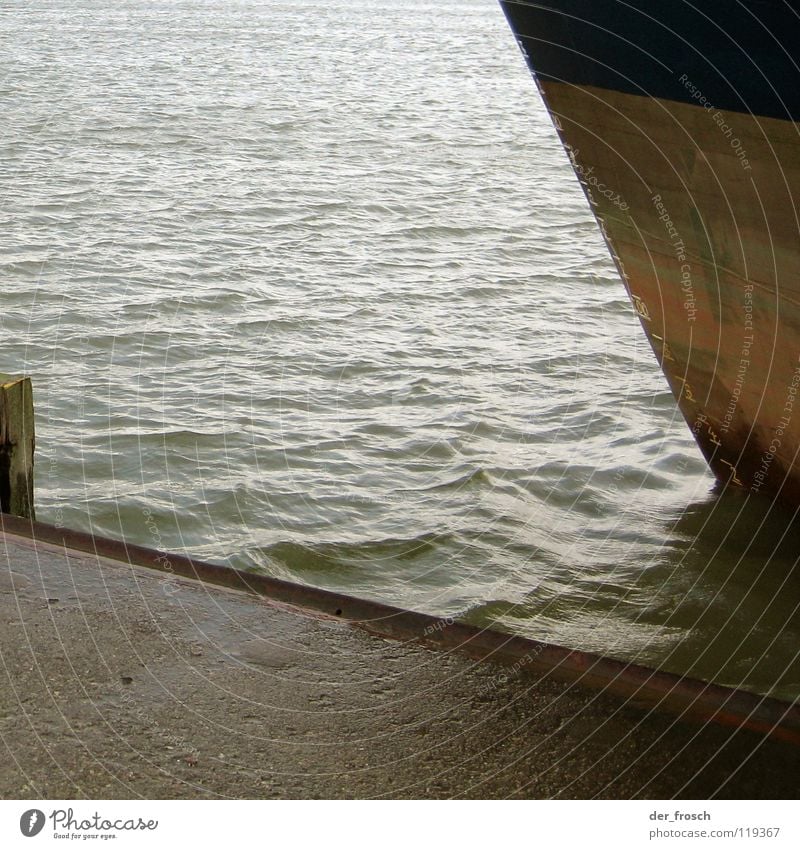 docked Jetty Mole Draft Drop anchor Ocean Watercraft Cargo-ship Gloomy Autumn Gray Hull Navigation Industry Harbour North Sea