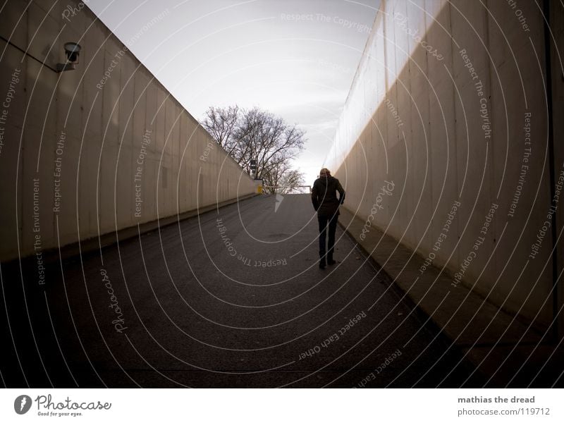 LONELY WALK Winter Dreary To go for a walk Going Loneliness Gray Incline Dark Threat Black Concrete Tunnel Facade Cast iron Asphalt Highway ramp (entrance)