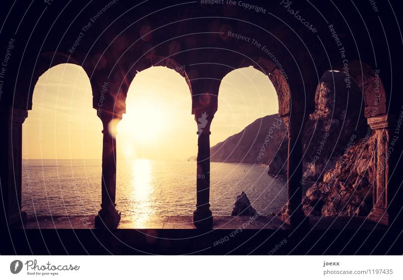 Seeing the sea in silence Nature Water Sky Horizon Sun Sunrise Sunset Sunlight Summer Beautiful weather Mountain Coast Ocean Ruin Facade Window Column