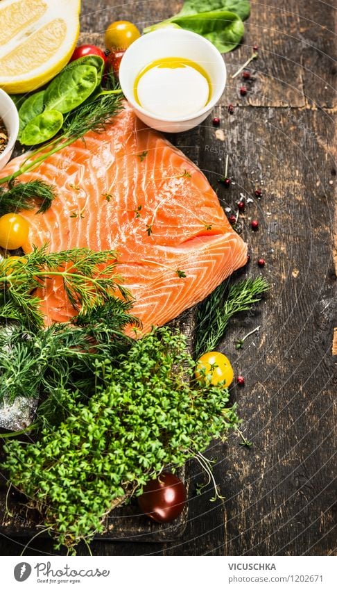 Salmon fillet with oil and fresh herbs on the wooden table Food Fish Vegetable Lettuce Salad Herbs and spices Cooking oil Nutrition Lunch Dinner Banquet