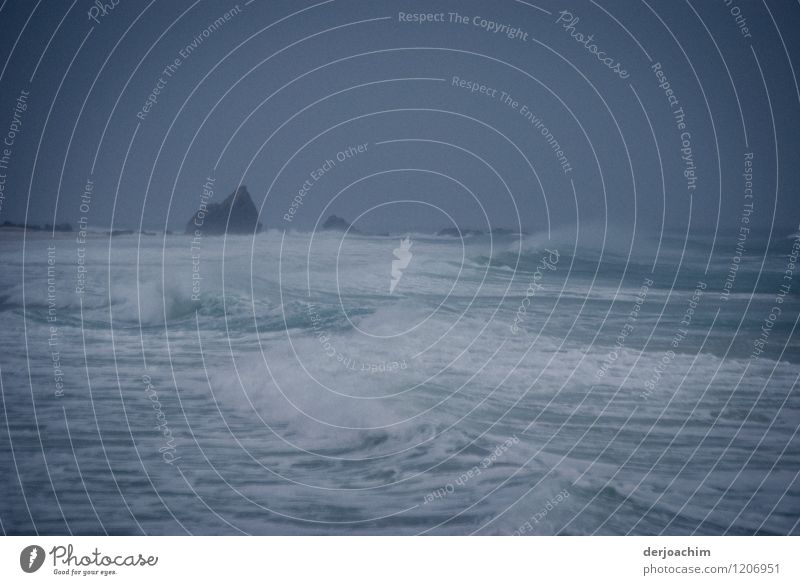 . Stormy sea / sea with strong surf. In the background rocks are visible. Dark sky . at the end of the world Exotic Swimming & Bathing Environment Water Summer