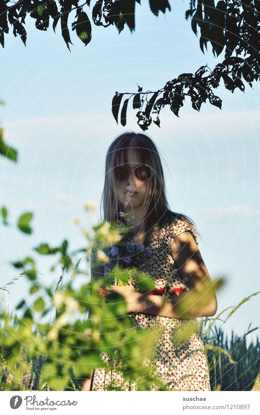 In the shade Child Girl Face Sunglasses Dark Shadow Exterior shot Summer Warmth Branch Leaf Sunlight Sky