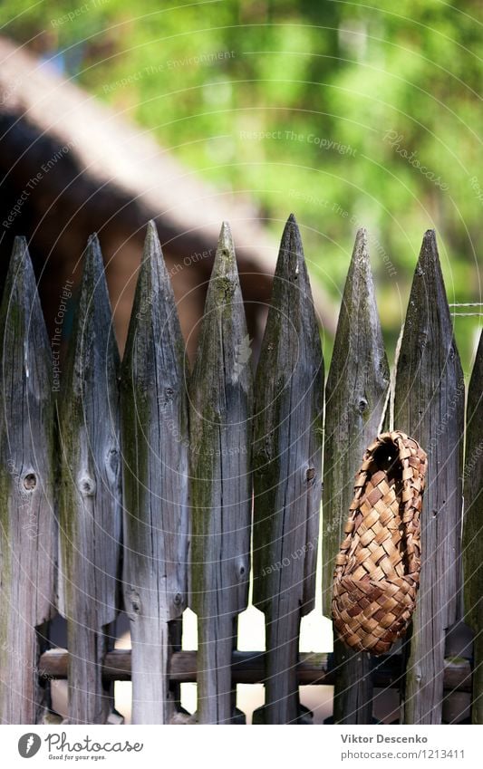 Bast shoes hanging on an old fence Decoration Culture Nature Village Clothing Footwear Old Historic Natural Retro White Tradition Sandal wicker Material