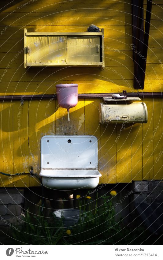 Pink washbasin on the yellow wall of old country house Style Design House (Residential Structure) Furniture Bathroom Metal Dirty Green Black White Sink faucet