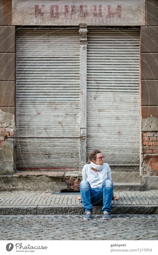 Young woman sitting on sidewalk in front of abandoned house Human being Feminine Youth (Young adults) Woman Adults Life 1 Spreewald Small Town Old town Ruin