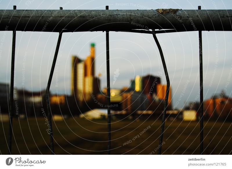 Potsdamer Platz behind golf course Middle Landmark Golf course Fence Metalware Wire fence Grating Barrier Blur House (Residential Structure) High-rise