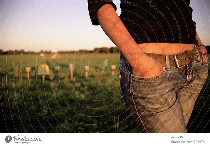 Watching the airplanes Flying Goodbye Reunion Fence Return Progress Flight path Come Arrival Observe Summer Sunset Tanned Brown Hand Bag Sweater Belt Lamp Grass