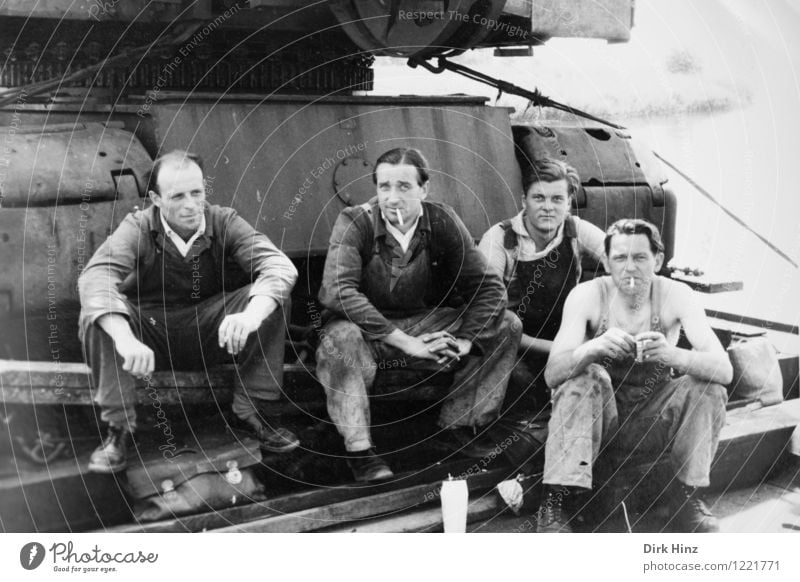 Four workers pause on a construction machine in the 50s Work and employment Profession Craftsperson Workplace Construction site Economy Team Human being