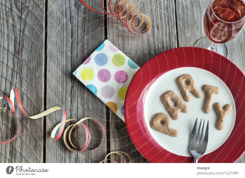 The letters PARTY on a plate with napkin, champagne glass and streamers Nutrition Beverage Cold drink Sparkling wine Prosecco Crockery Plate Glass