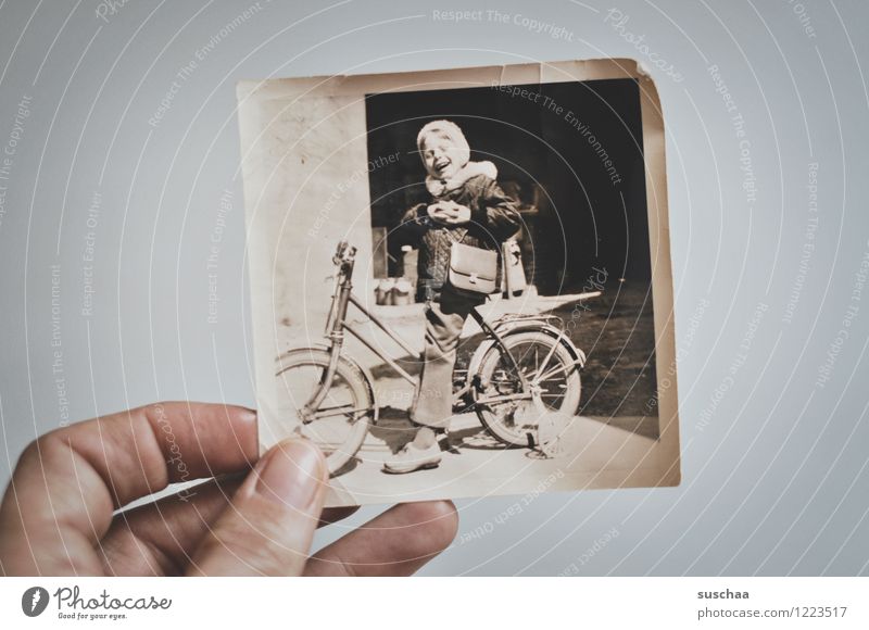 old black and white photo of a child on a bicycle with support wheels Photography Analog Old Black & white photo Hand Child Bicycle Tricycle Memory Infancy Past