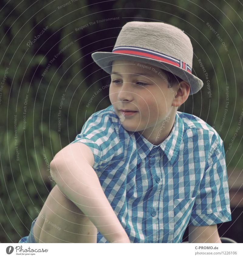 Boy in hat looks away happy Human being Masculine Boy (child) Infancy 1 8 - 13 years Child Shirt Hat smile Sit Blue green Contentment Self-confident