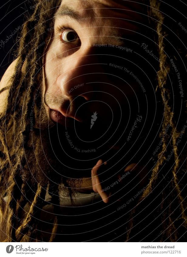 view Dreadlocks Felt Long Dark Upper body Man Masculine Concealed Facial hair Beard hair Unshaven Light Visual spectacle Shadow play Pants Chin Abrupt