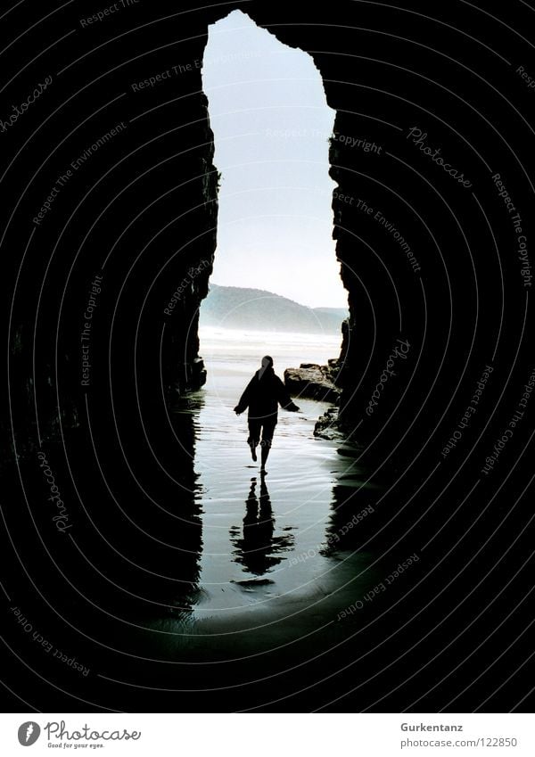 shadow running New Zealand South Island Cave Ocean Beach Reflection Walking Wet Low tide Tide Coast Black & white photo Mountain cavern Cathedral cathedral cave