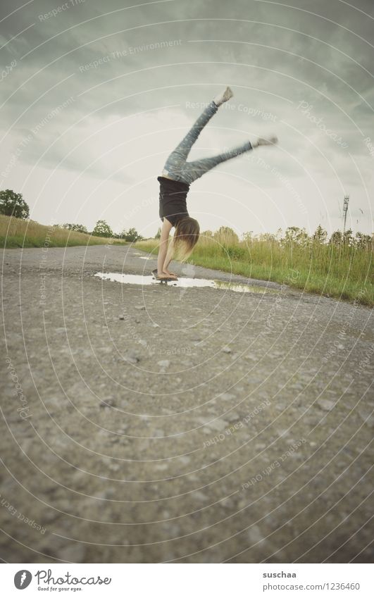 the handstand .... Lanes & trails Asphalt Exterior shot Footpath Puddle Wet Child Girl Handstand Athletic Skateboarding Stunt Dangerous Brave Infancy Freedom