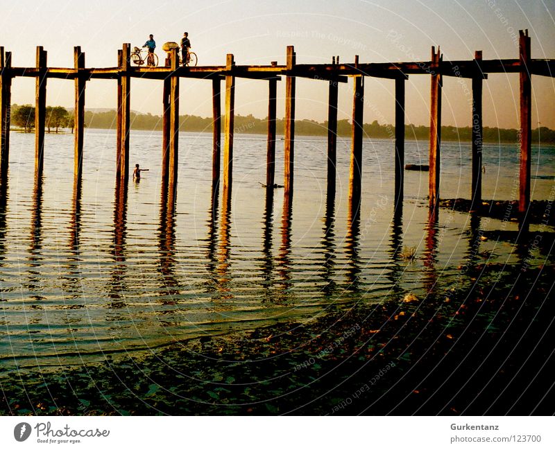 Bridge over silent water Myanmar Mandalay Teak Wood Wooden bridge Asia Dusk Lake Burmese Transport River Brook u-leg Pole Evening Water Shadow Silhouette