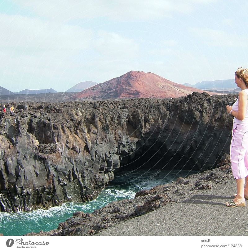 Lanzaro(u)te Woman Lanzarote Landscape Background picture Horizon Peak Stony Gloomy Plant Ocean Lake Stone Hiking Vacation & Travel Clouds Bad weather Asphalt