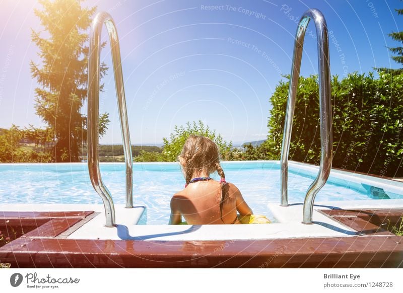 Girl splashing at the pool side Life Summer Swimming pool Child Human being Nature Swimming & Bathing Water Sit Garden Beautiful weather Sunbeam Braids