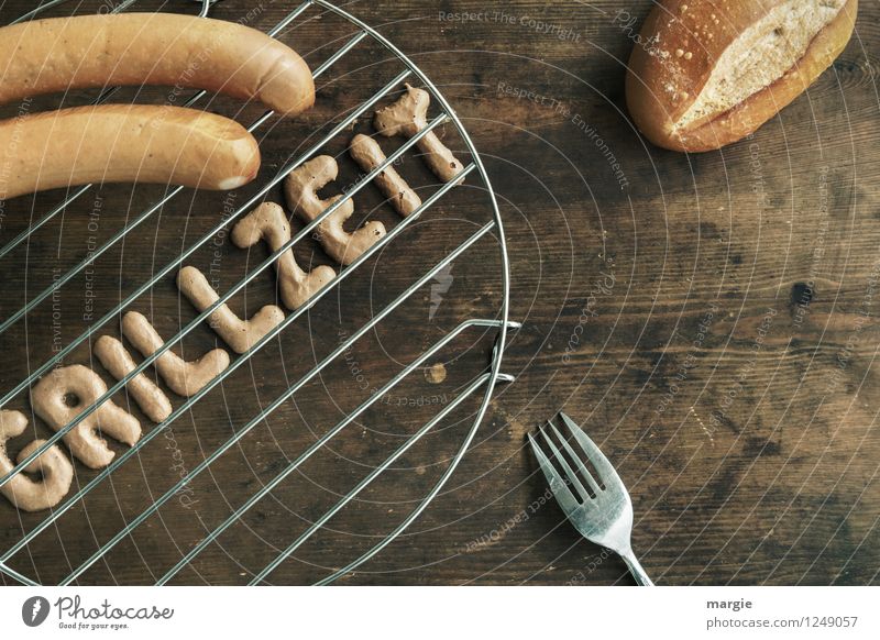 The letters GRILLZEIT on a grill, two sausages, a bread roll and a fork on a rustic wooden table Food Meat Sausage Roll BBQ Boiled sausage Bratwurst Nutrition