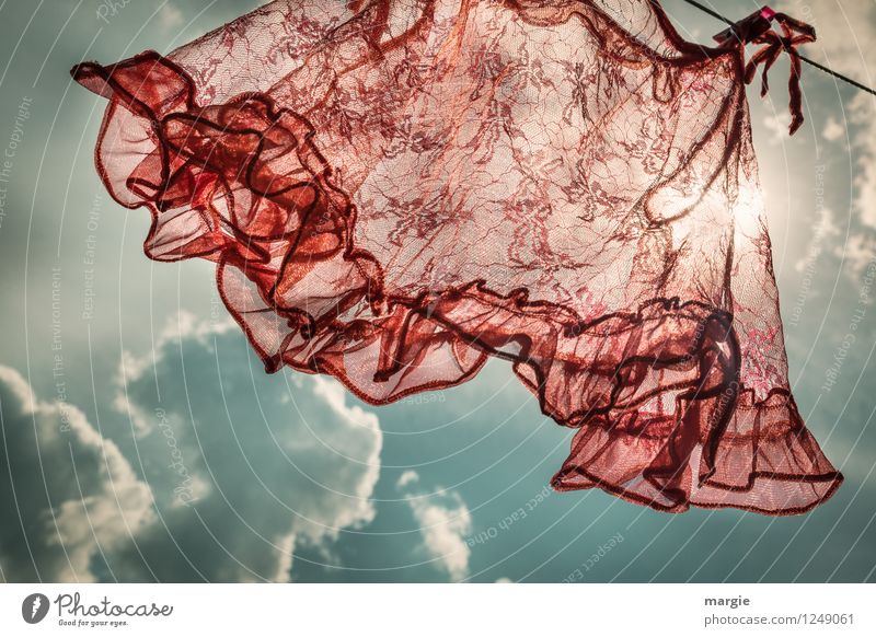 A red lady - shirt flutters on a clothesline in the wind Sky Clouds Storm clouds Sun Solar eclipse Summer Beautiful weather Bad weather Thunder and lightning