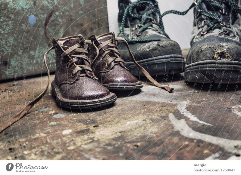 Old shoes from father and little son on a rustic wooden floor Parenting Work and employment Craftsperson Workplace Craft (trade) Construction site Footwear