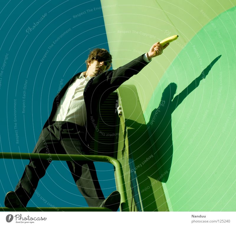 R E L O A D E D : shot Agent Suit Man Sunglasses Masculine Green Matrix Shoot Fellow Banana Wall (building) Aim Posture Force Brutal Evil Bad guy Multicoloured