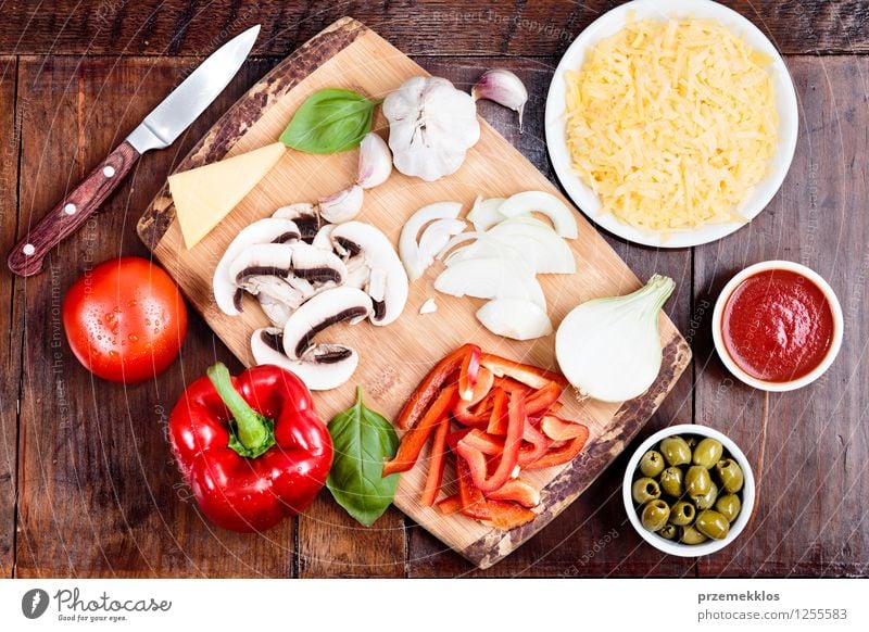 Fresh ingredients for homemade pizza Food Cheese Vegetable Dinner Fast food Bowl Knives Table Leaf Basil board cuisine Garlic Grating grated Home Home-made