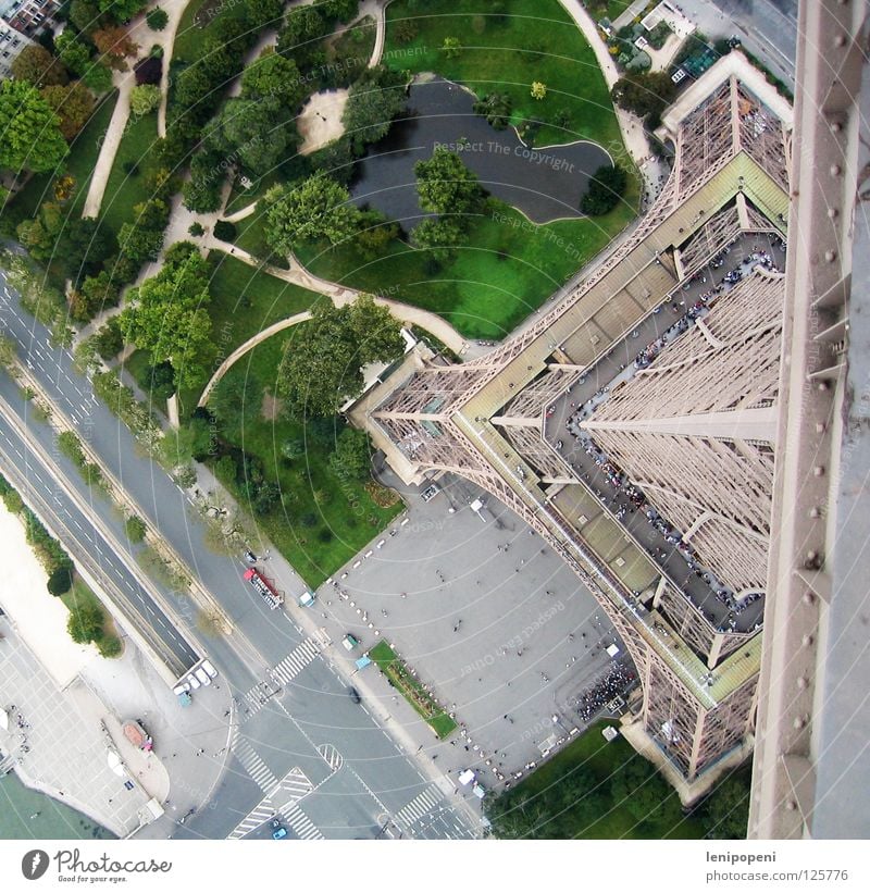 On a small foot Eiffel Tower Paris France Steel Iron Landmark Famousness Bird's-eye view Dangerous Deep Small Reaction Under Park Carrier Wind Pond