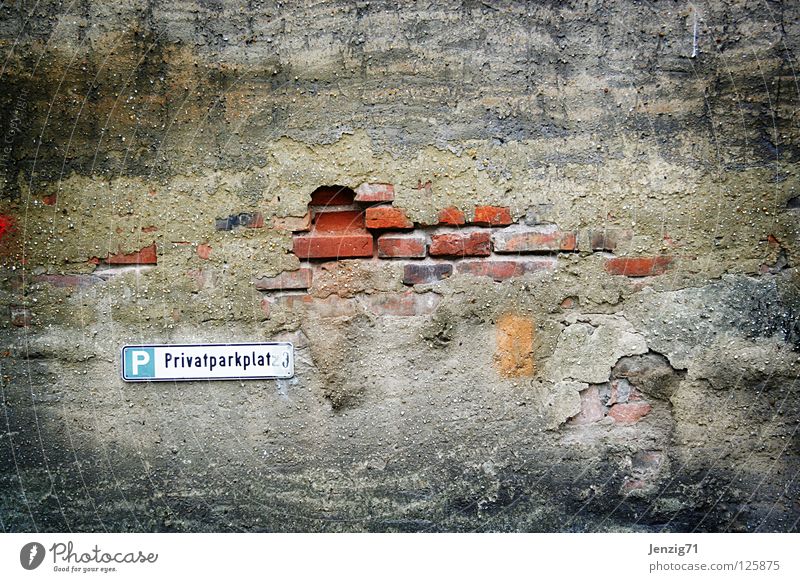 Parking costs extra. Parking lot Wall (barrier) Old fashioned Brick Derelict Signs and labeling rotten Rent free parking