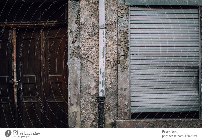 locked up, abandoned and neglected Deserted House (Residential Structure) Facade Door Roller shutter Old Creepy Broken Loneliness Apocalyptic sentiment